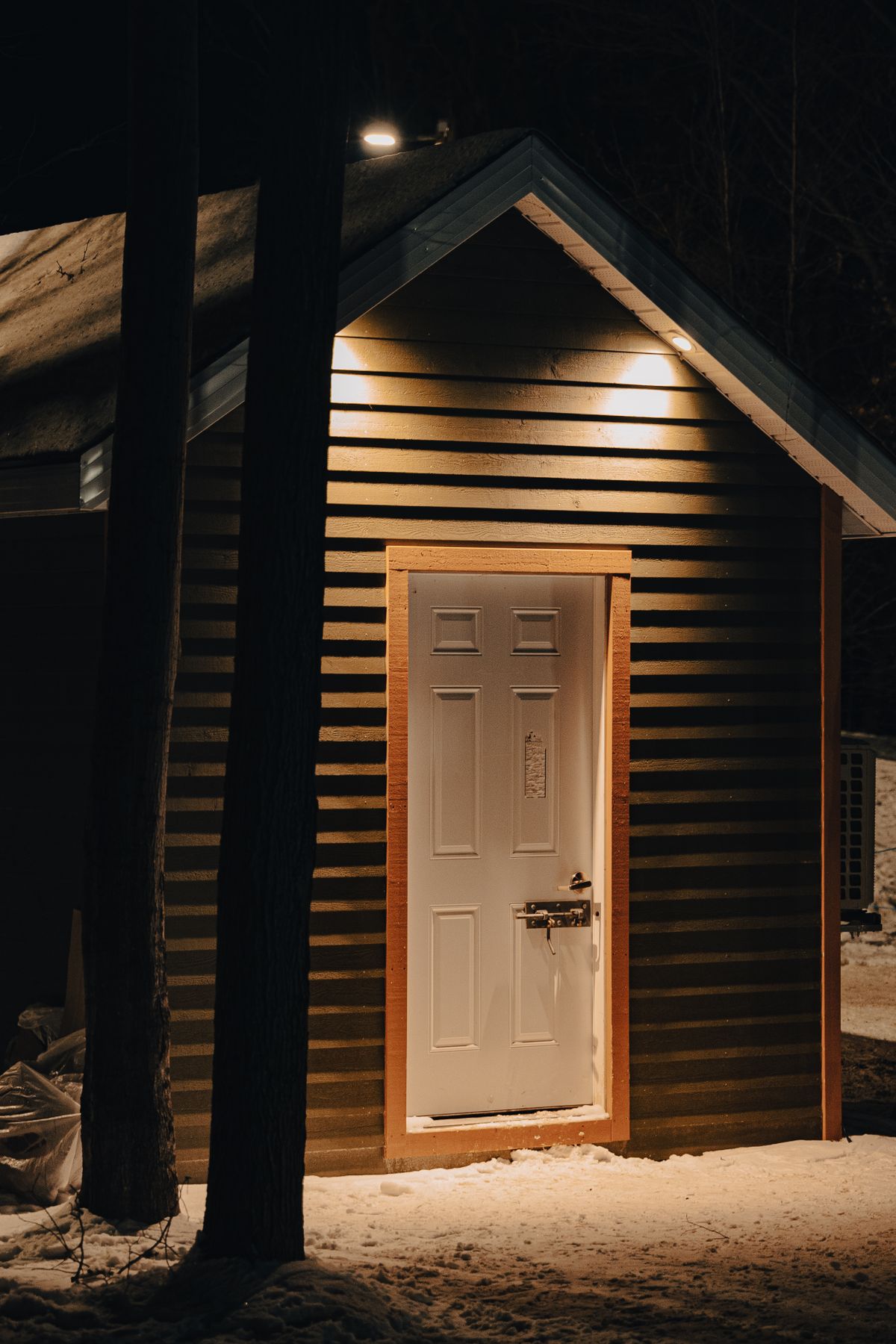 Home lit up at night in deep winter snow