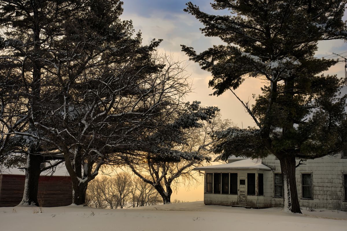 Rural Minnesota homestead in winter at dusk