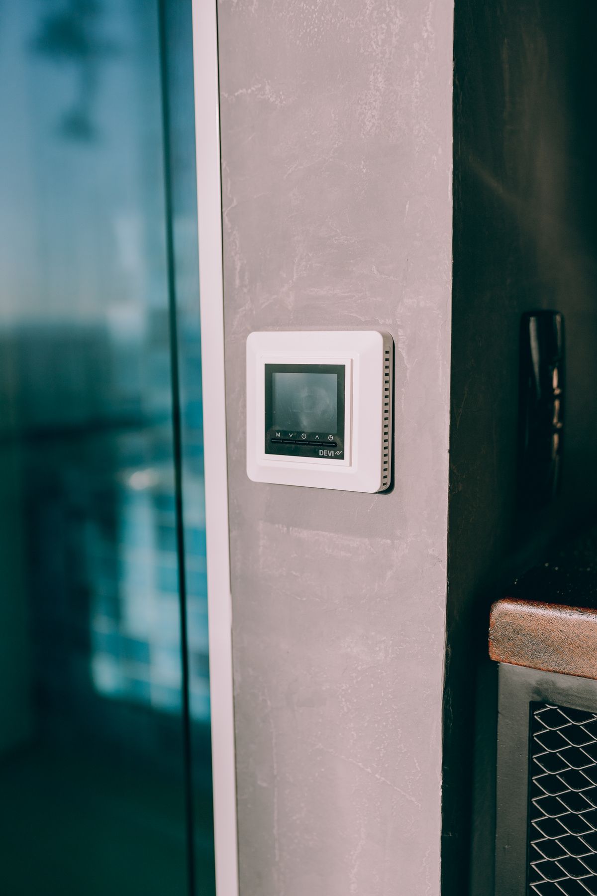 Smart thermostat mounted on an interior wall